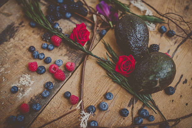 Berries, plums and avocados on barnwood