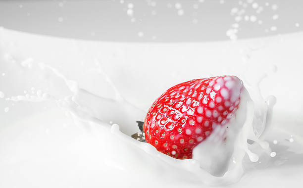 istock Dessert: strawberry falling in milk with splashes. Red and white 518384890