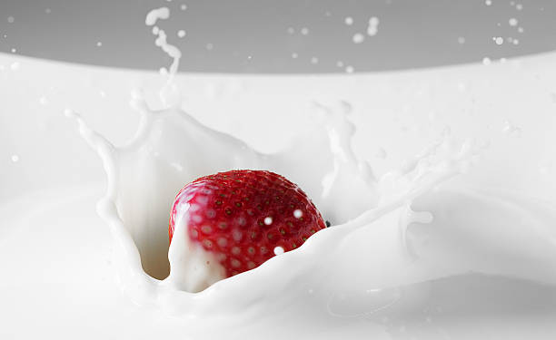 istock Dessert: strawberry falling in milk with splashes. Red and white 518384930