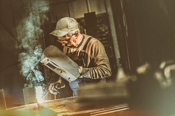 istock Craftsman welder at work in a small factory 518385118