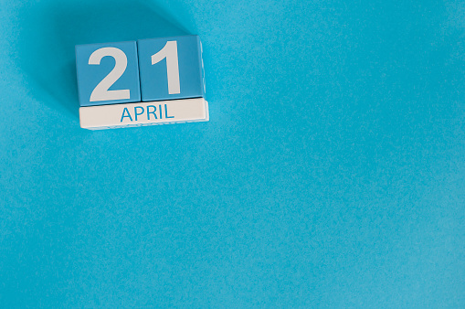 April 21st. Image of april 21 wooden color calendar on blue background.  Spring day, empty space for text.
