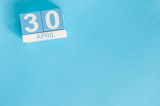 April 30th. Image of april 30 wooden color calendar on blue background.  End month. Spring day, empty space for text. International Jazz Day.