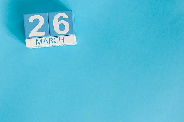 March 26th. Image of march 26 wooden color calendar on blue background.  Spring day, empty space for text. Purple DAy is the international day for epilepsy awareness