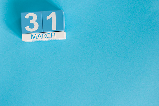 March 31st. Image of march 31 wooden color calendar on blue background.  Spring day, empty space for text. World Backup Day and the month end.
