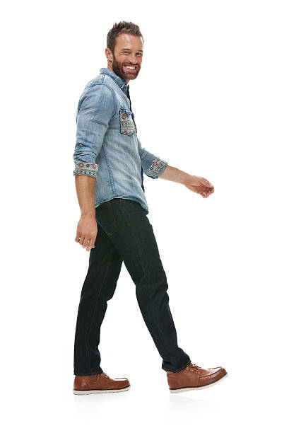 istock Smiling man walking and looking at camera 518386398