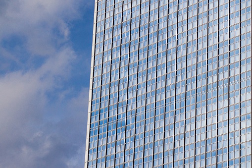 Blue sky reflection in the glass facade of a building. Cherry Creek district, Denver, Colorado