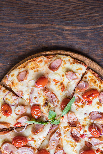 istock spicy sausage pizza on wooden table, Top view 518397222