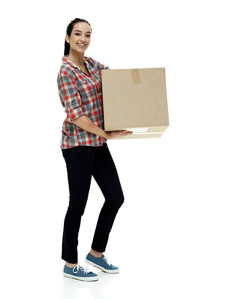 istock Smiling female holding box and moving 518397448