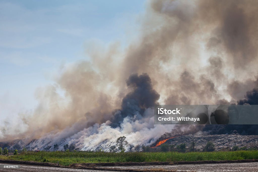 Burning garbage heap of smoke Burning garbage heap of smoke from a burning pile of garbage Accidents and Disasters Stock Photo