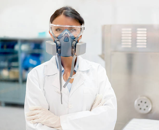 Chemist working at a chemical plant Chemist working at the lab in a chemical plant wearing protective wear gas mask stock pictures, royalty-free photos & images