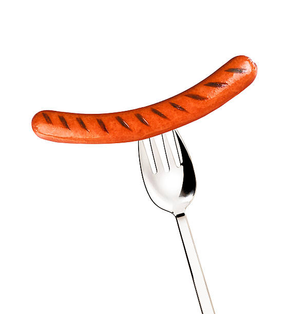 istock Close-up of fried sausage on a fork 518402135