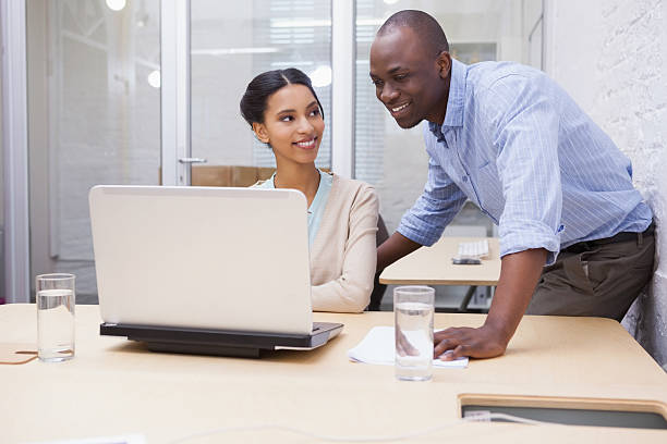 istock Business team working happily together on laptop 518402955