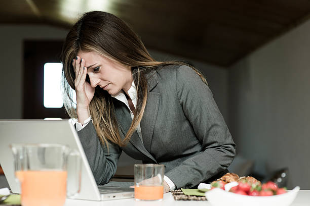 istock Tired/Exhausted Businesswoman Having Breakfast And Working 518404115