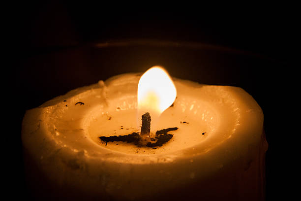 istock Candle light with gentle steady flame in dark surrounding 518404137