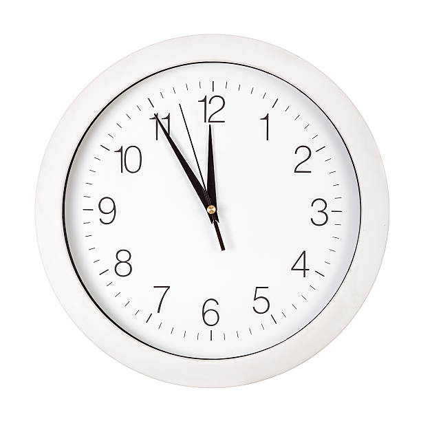 istock Clock face showing five minutes to twelve 518404147