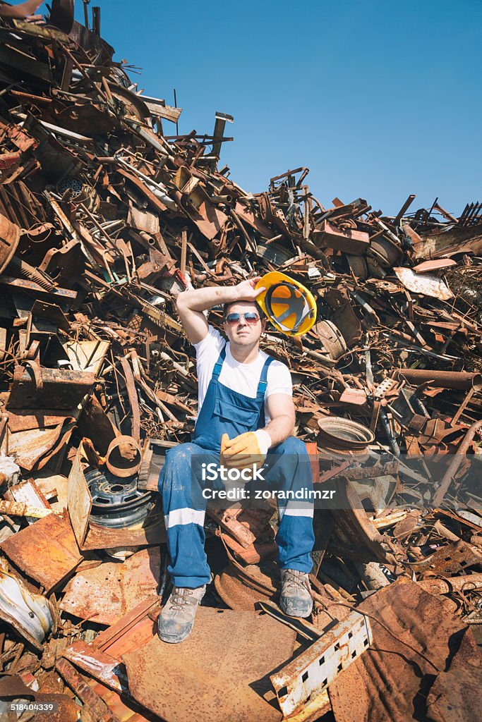Worker in a junkyard Junkyard Stock Photo