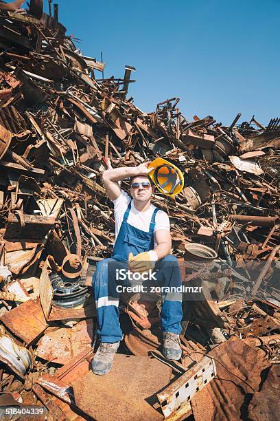 Worker In A Junkyard Stock Photo - Download Image Now - Junkyard, Recovery, Scrap Metal