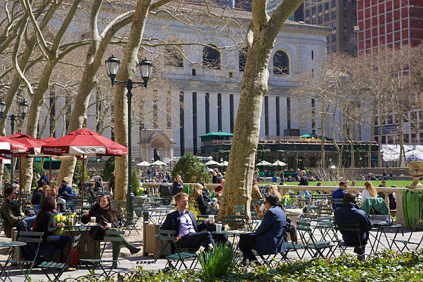 People Enjoying Bryant Park on a Sunny Early Spring Day stock photo