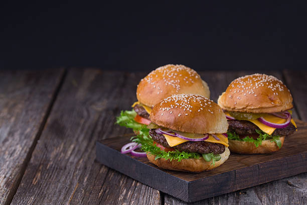 istock Three juicy beef burgers 518407508