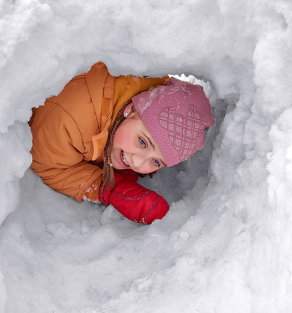 istock The girl in a snow hole 518411032