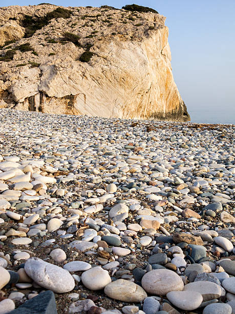 istock Pebble stones on coastline blurred by transparent sea water 518411844