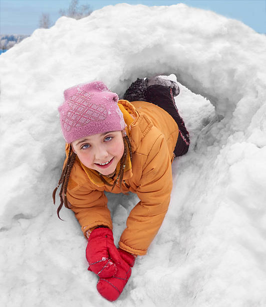 istock The girl in a snow hole 518411886