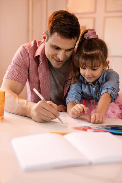 istock Young father and daughter drawing at home. 518412228