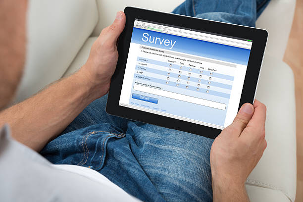 istock Person With Digital Tablet Showing Survey Form 518414048
