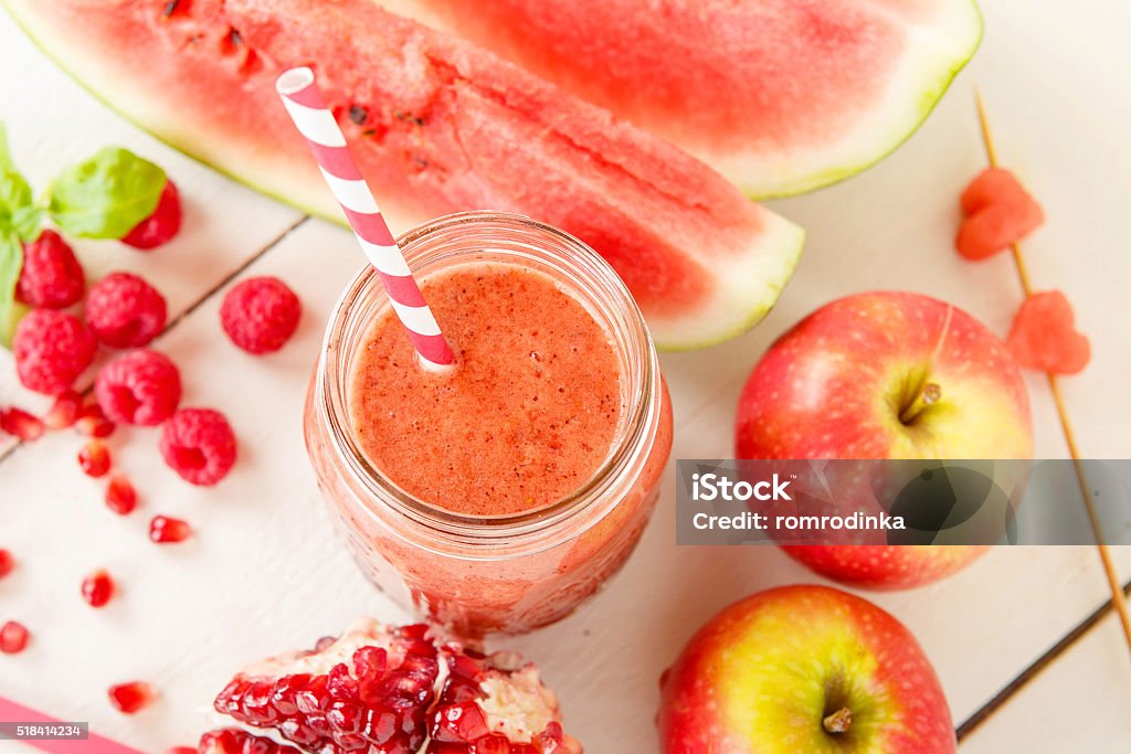 organic red smoothie with apple, watermelon, pomegranate, raspbe Fresh organic red smoothie with apple, watermelon, pomegranate, raspberry, strawberry as healthy drink. Vegan snack juice. Apple - Fruit Stock Photo