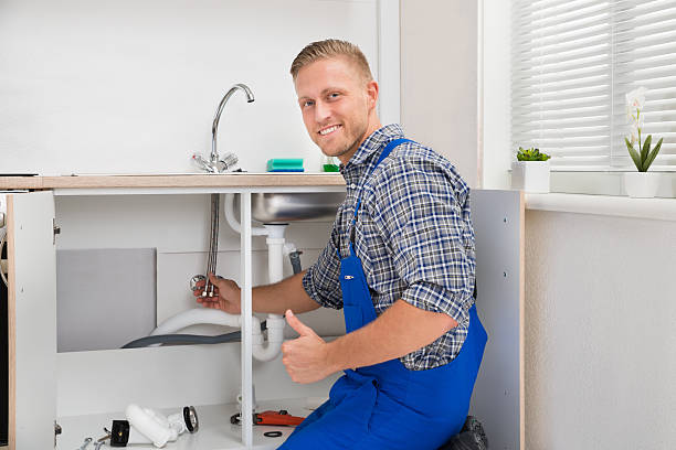 istock Plumber Repairing Faucet In Kitchen 518423306