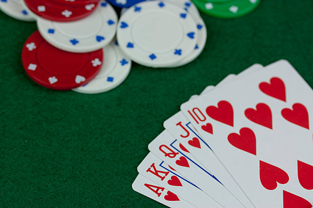 istock Poker chips and cards on a green table 518424068