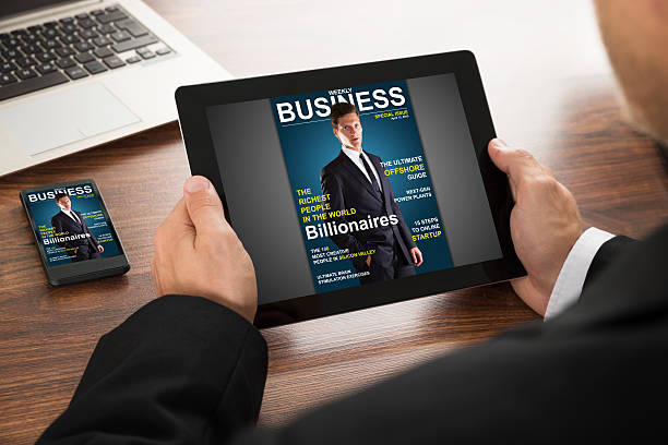 istock Businessman Reading Online Magazine 518424558