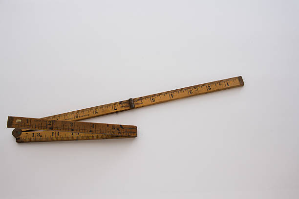 istock Bending the rules..a bent wooden ruler illustrates this. 518425209
