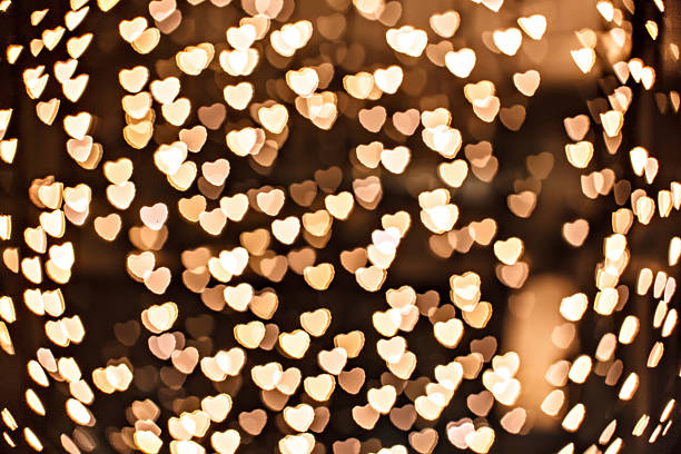 istock Defocused yellow sparkles - gold heart 518425417