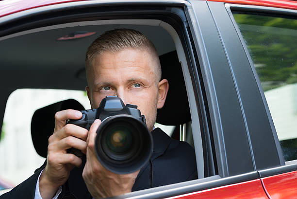 istock Man Photographing With Slr Camera From Car 518425438