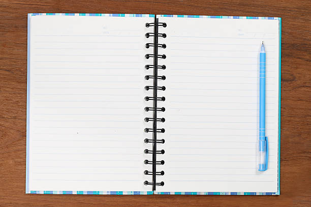 istock Notebook with a pencil on wood floors. 518426734