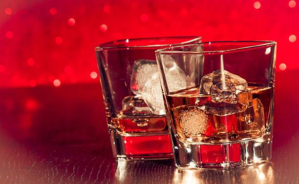 istock whiskey glass with ice in front of empty whiskey glass 518426992