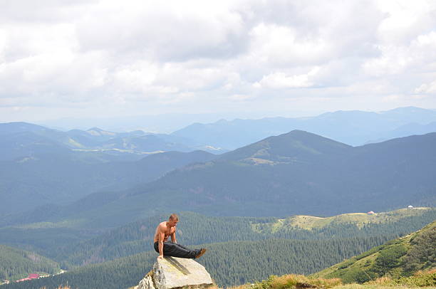 istock Male gymnast doing gymnastic exercise in the mountains 518427328