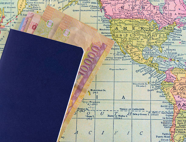 istock passport with money on world map background 518427440