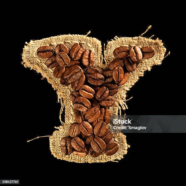 Alphabet From Coffee Beans On Fabric Texture Isolated On Black Stock Photo - Download Image Now