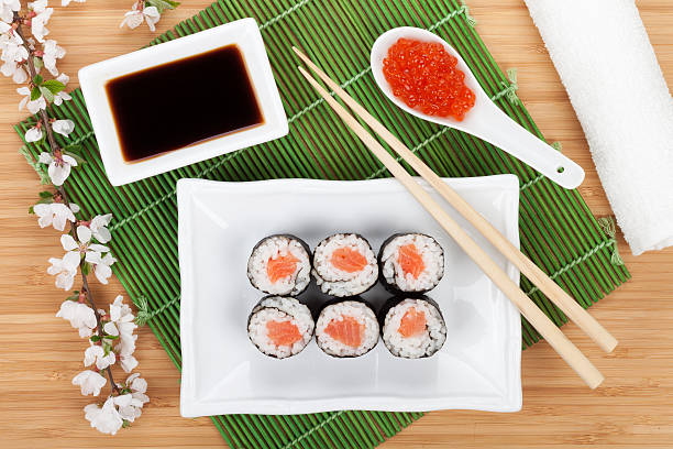 istock Red caviar, sushi set, sakura branch and chopsticks 518428625