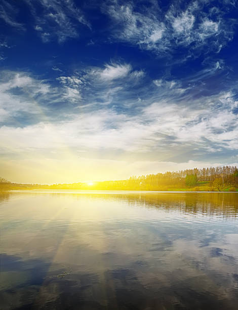 istock Hot sunset in nice sky over water 518428688