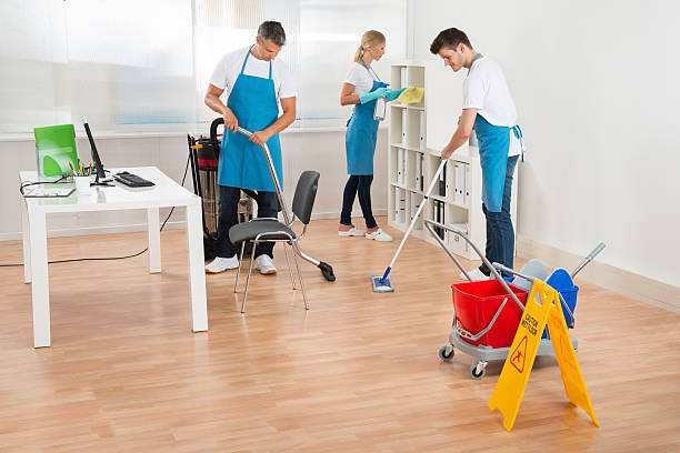 istock Janitors In Blue Apron Cleaning Office 518428936