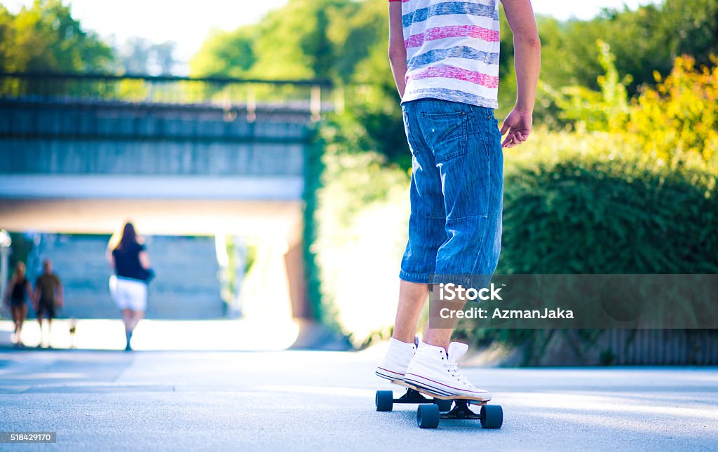Skaterboy A rear view of a young man skateboarding in the city 20-29 Years Stock Photo