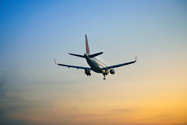 istock The passenger plane which flies in the nightfall sky 518429538