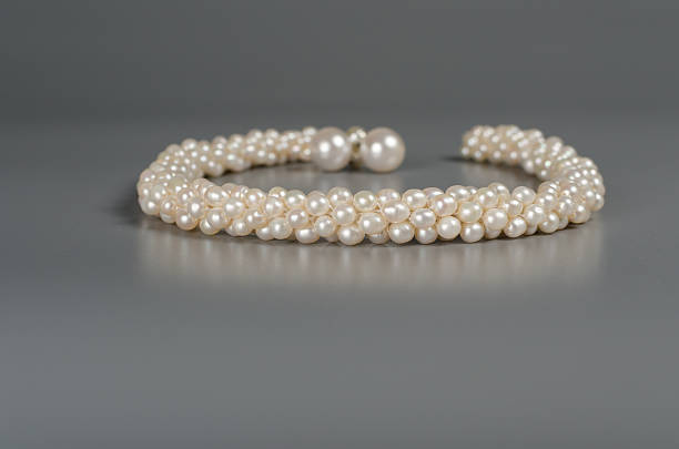 istock pearl necklace on gray background 518430030