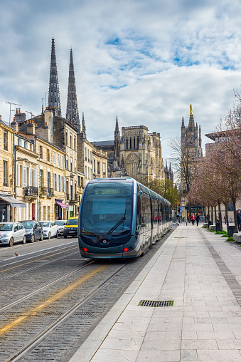 Bordeaux, France - March 26, 2016: ﻿Tram rolling near to Cathedral of St. Andre.﻿Saint Andre is a gothic cathedral of Bordeaux, capital of Aquitaine.