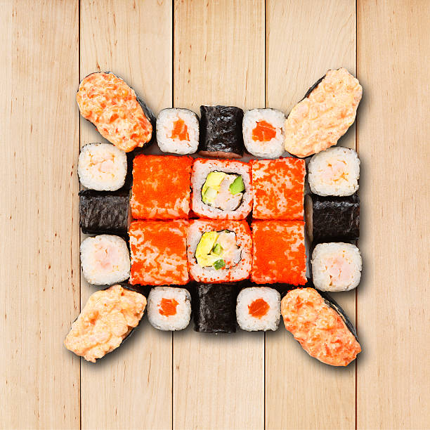 Set of sushi, maki and rolls isolated at wood