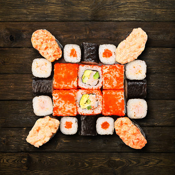 Set of sushi, maki and rolls isolated at wood