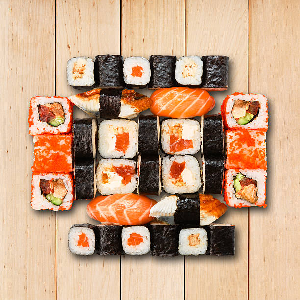 Set of sushi, maki and rolls isolated at wood